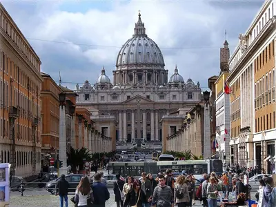 a crowd of people walking down a street in front of a building at Trevi Fountain House Deluxe in Rome