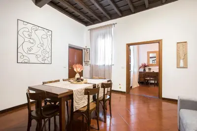 a dining room with a table and chairs at Trevi Fountain House Deluxe in Rome