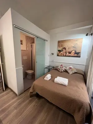 a bedroom with a bed with two towels on it at Marcelina vaticans rooms in Rome