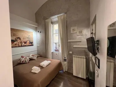 a bedroom with a bed with towels on it at Marcelina vaticans rooms in Rome