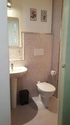 a bathroom with a white toilet and a sink at Marcelina vaticans rooms in Rome
