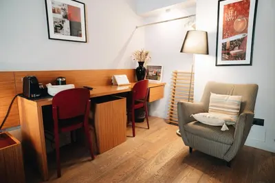 a room with a desk and a chair and a desk and a lamp at DownTown Boutique House - CA Domus Collection in Rome