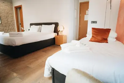 two beds in a hotel room with white sheets at DownTown Boutique House - CA Domus Collection in Rome