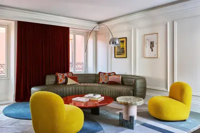 a living room with a couch and two chairs at W Rome in Rome