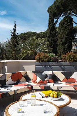 a table with a bowl of fruit on a patio at W Rome in Rome