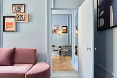 a living room with a pink couch and a mirror at W Rome in Rome