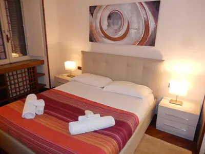 a bedroom with a bed with two towels on it at Colosseo Homerents 2 in Rome