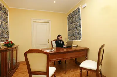 a man sitting at a desk with a laptop at DG Prestige Room in Rome