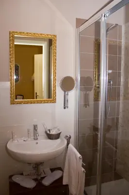 a bathroom with a sink and a shower with a mirror at DG Prestige Room in Rome