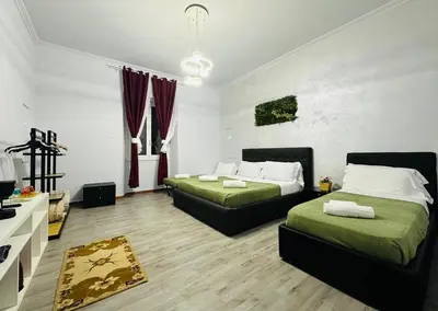 a bedroom with two beds and a living room at Termini luxury home in Rome