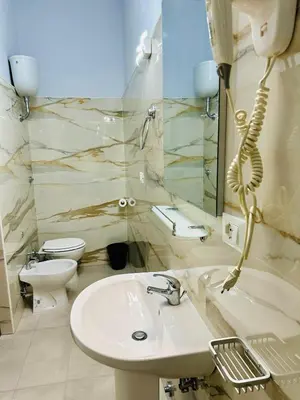 a bathroom with a sink and a toilet at Termini luxury home in Rome