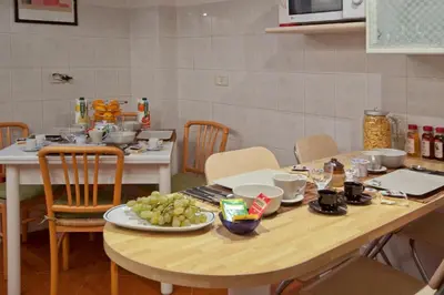 a dining room table with a plate of food on it at Light of Rome in Rome