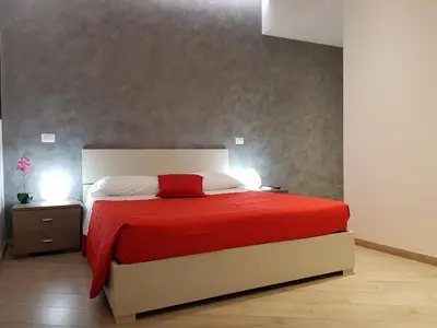 a bedroom with a large bed with a red blanket at Domus Barberini in Rome