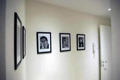 a group of framed pictures on a wall at Domus Barberini in Rome