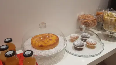 a table with a cake on a plate and cupcakes at Domus Barberini in Rome