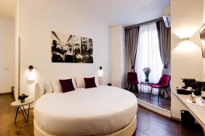 a bedroom with a large white bed in a room at V Collection Piazza Farnese Luxury Suites in Rome