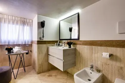 a bathroom with a sink and a mirror at V Collection Piazza Farnese Luxury Suites in Rome