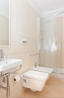 a bathroom with a white door and a sink at Al Centro Storico Roma Suite in Rome