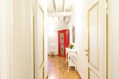 a room with a white door and a table with chairs at Al Centro Storico Roma Suite in Rome