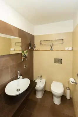 a bathroom with a toilet and a sink at SuitInn19 in Rome