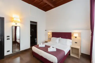 a bedroom with a bed with two towels on it at SuitInn19 in Rome