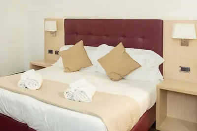 a bedroom with a large bed with towels on it at SuitInn19 in Rome