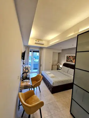 a bedroom with a bed and a table and chairs at Appia Avenue 639 in Rome
