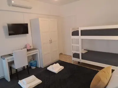 a bedroom with a desk and a bunk bed at Appia Avenue 639 in Rome