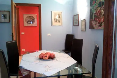 a dining room table with a plate of fruit on it at Appartamento Isabella in Rome