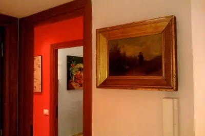 a painting hanging on a wall next to a door at Appartamento Isabella in Rome
