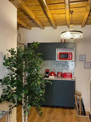 a kitchen with red appliances and a tree at B&B Ventisei Scalini A Trastevere in Rome