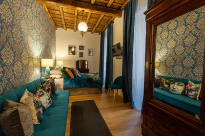 a living room with a couch and a bed at B&B Ventisei Scalini A Trastevere in Rome