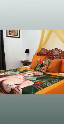 a bedroom with a bed with anricaninspired bedspread at B&B Ventisei Scalini A Trastevere in Rome