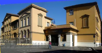 a woman walking in front of a building at Simon Holiday House in Rome