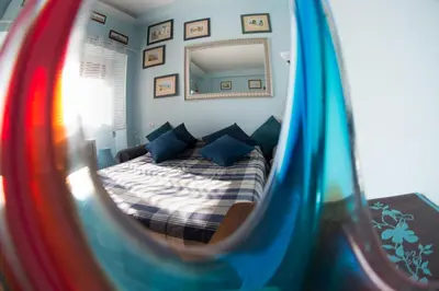 a bedroom with a bed and a mirror at Simon Holiday House in Rome