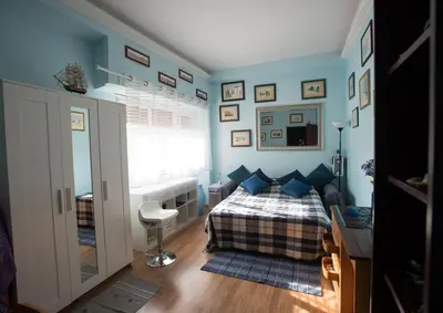 a bedroom with a bed with blue walls and a window at Simon Holiday House in Rome