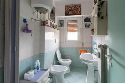 a bathroom with two toilets and two sinks at Simon Holiday House in Rome