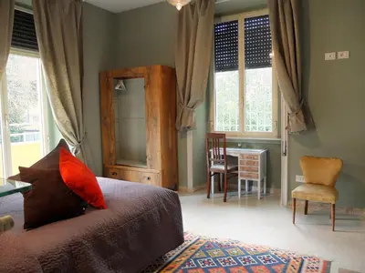 a bedroom with a bed and a table and chairs at Dimora Al 36 in Rome