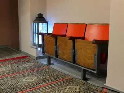 a group of orange chairs in a room with a rug at Dimora Al 36 in Rome