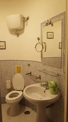 a bathroom with a toilet and a sink and a mirror at Luiza Vatican House in Rome