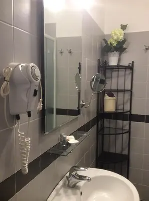 a bathroom with a sink and a mirror at Luiza Vatican House in Rome