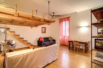 a living room with a couch and a table at Ponte Testaccio Loft in Rome