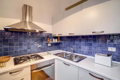 a kitchen with a sink and a stove at Ponte Testaccio Loft in Rome