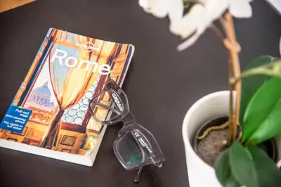a pair of scissors sitting on a table next to a magazine at San Pietro Holidays in Rome