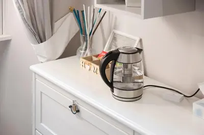 a black coffee maker sitting on top of a white cabinet at San Pietro Holidays in Rome