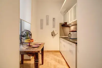 a kitchen with a wooden table with fruit on it at Elegant Apartment Behind the Colosseum in Rome