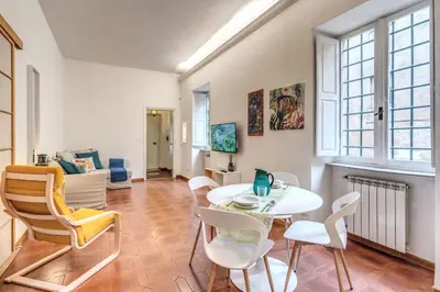 a living room with a white table and chairs at Elegant Apartment Behind the Colosseum in Rome