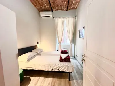a small bedroom with a bed and a window at Român Holidays in Rome
