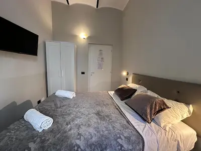 a bedroom with a large bed with two pillows at Român Holidays in Rome