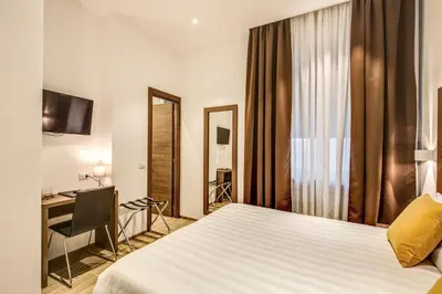 a hotel room with a bed and a desk at House Garden in Rome